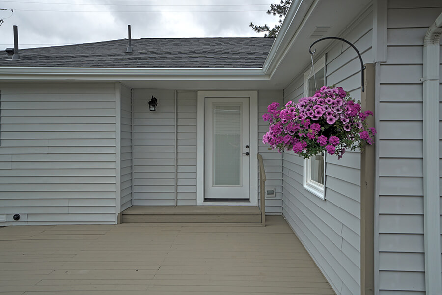Photo of back porch deck and glass insert back door.