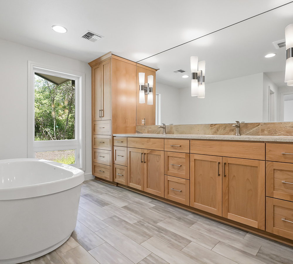 Photo of bathroom remodel with free-standing white tub.