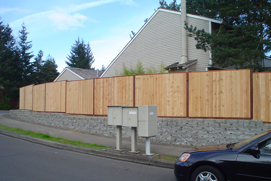 Photo of light colored wooden fence with darker wood framing.