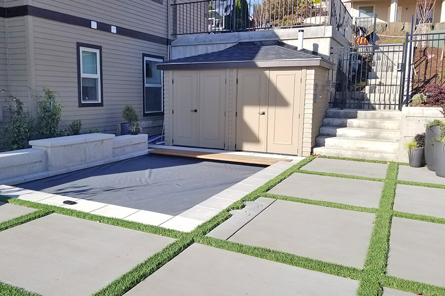 Photo of a concrete patio with grass inserts.