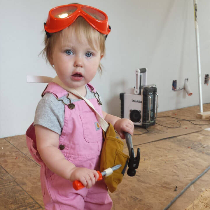 Photo of Ben's daughter with protective goggles and play building tools.