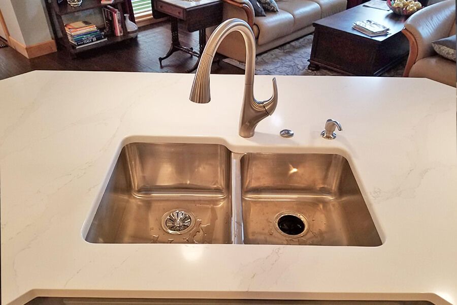 Photo of a kitchen island showing the sink and faucet.