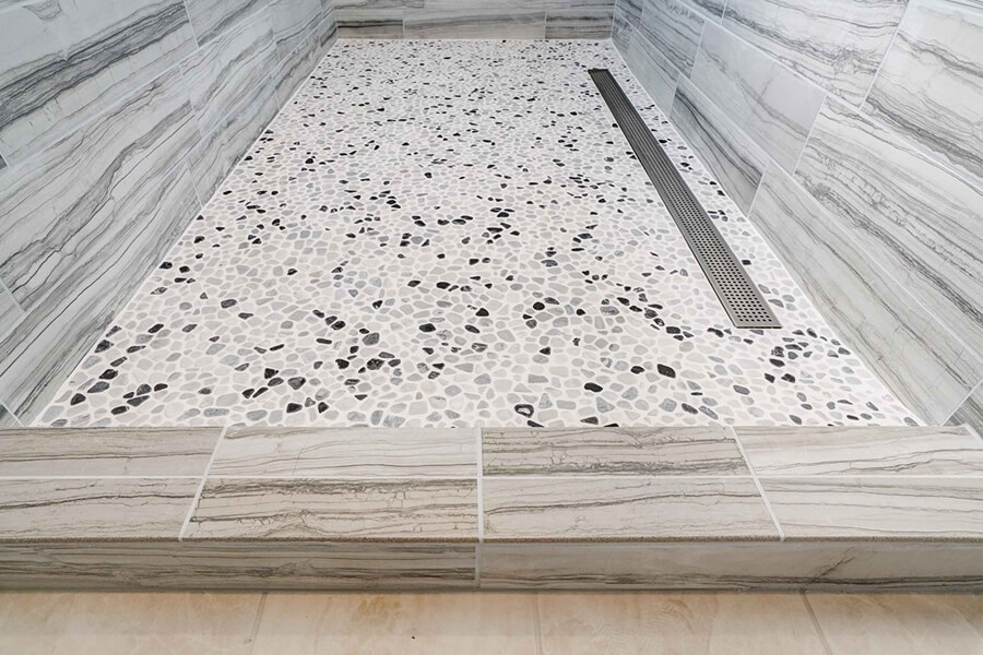 Close-up photo of a shower floor demonstrating the detail of the stone work.