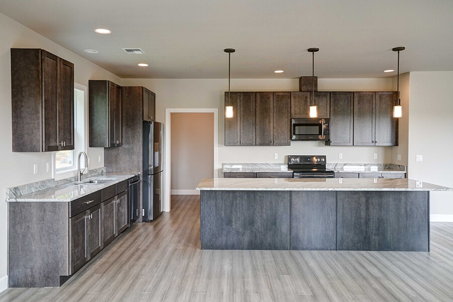 Photo of Contemporary Craftsman kitchen with slate grey cabinets, island, floors and pendant lights