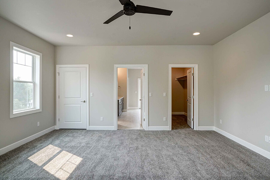 Photo of Contemporary Craftsman bedroom with gret carpet and white doors and trim