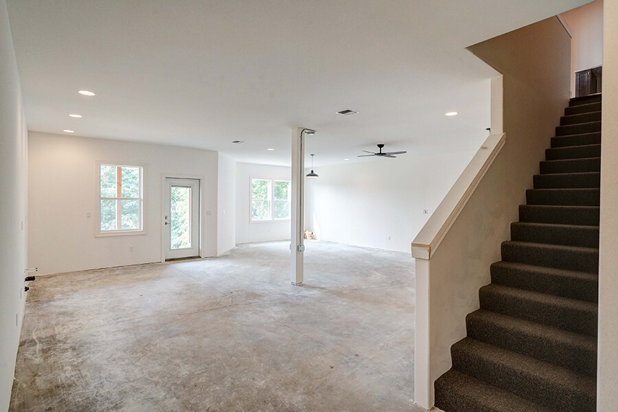 Photo of Contemporary Craftsman basement with glass insert door and large windows showing a lot of daylight