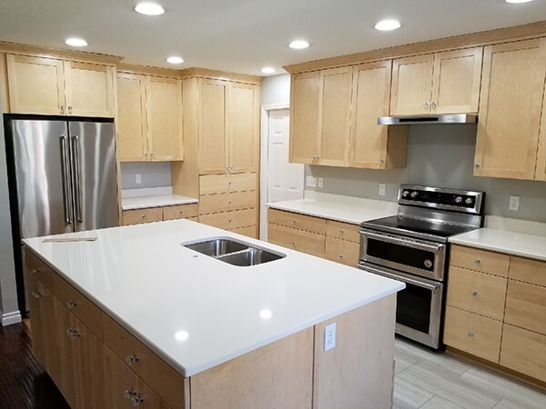 Photo of kitchen redesign with large island and open design