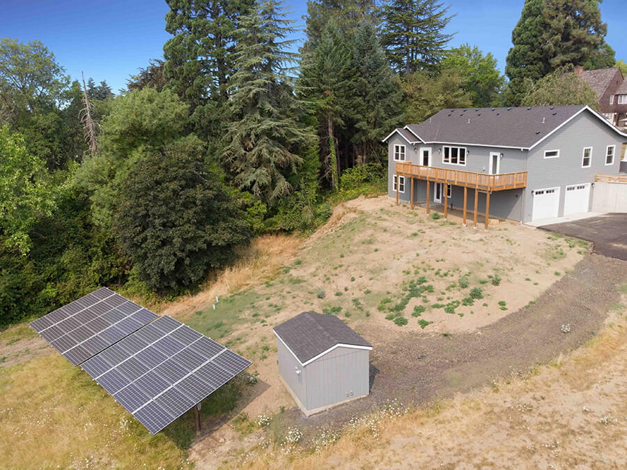 Photo of Contemporary Craftsman solar panels in the proprety behind the house and small out building