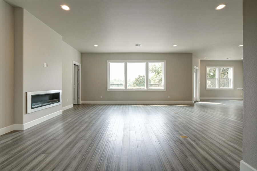 Photo of Contemporary Craftsman family room with grey flooring and fireplace.