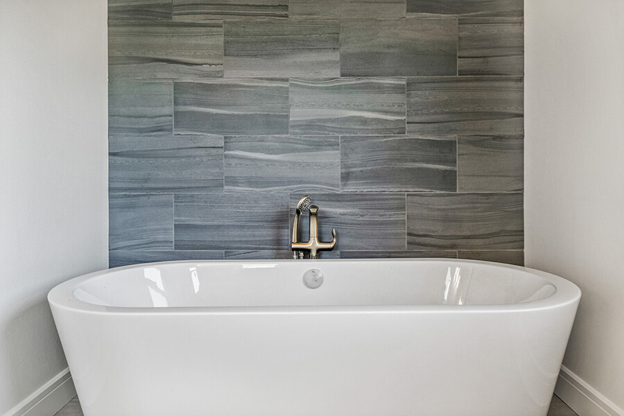 Modern Hilltop bathtub in front of tiled wall