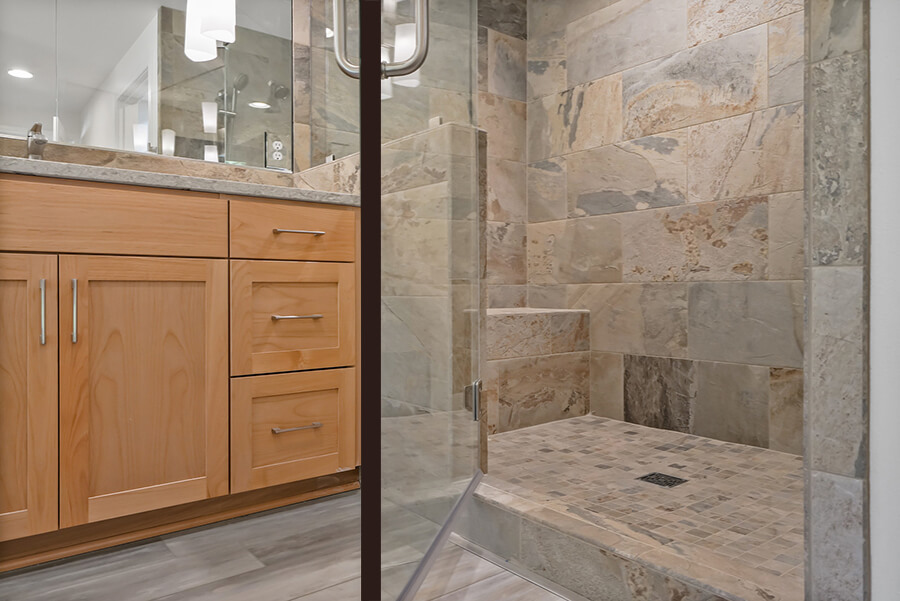 Photo of beige and grey marbled tile shower with glass door open.